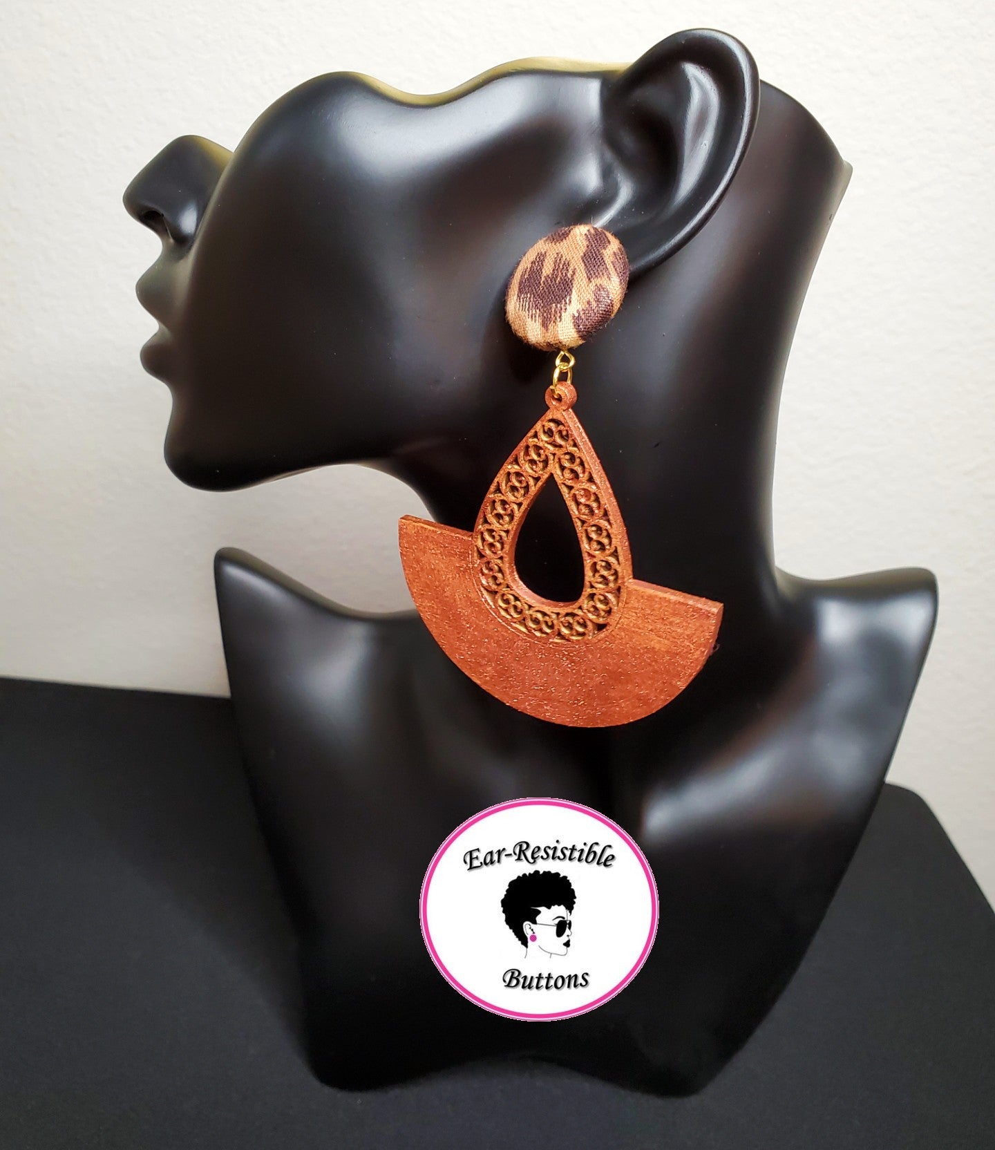 earring model wearing cheetah print button stud earring with attached copper colored wooden accessory